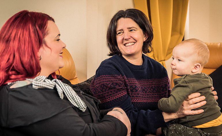 Family smiling in their living room