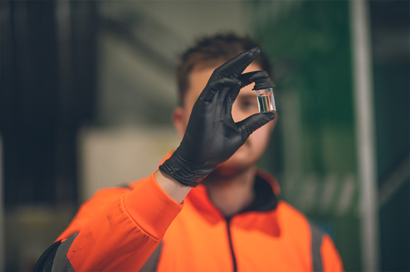 Water treatment operator looking at a water sample